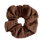 brown scrunchie with a floral pattern