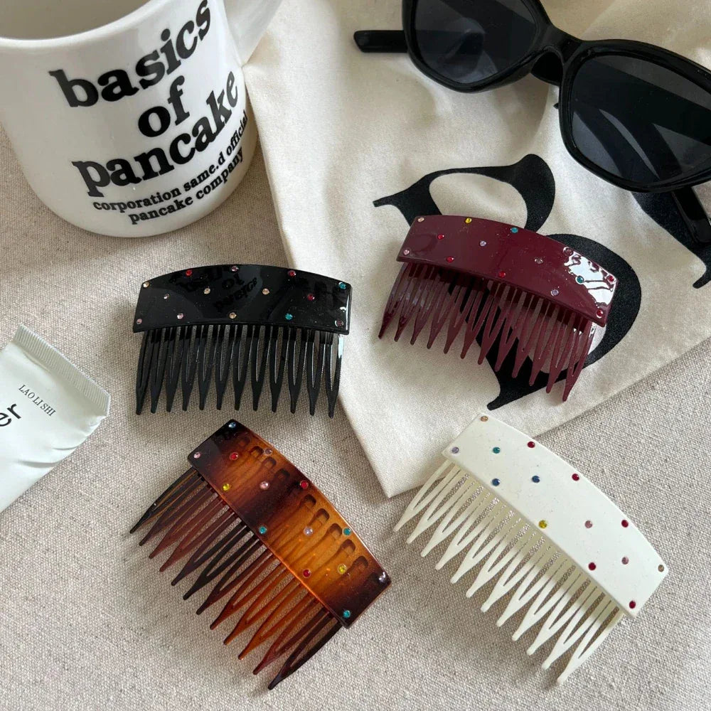 A collection of four decorative hair combs with rhinestones, presented with a mug, a tube of hand cream, and sunglasses.