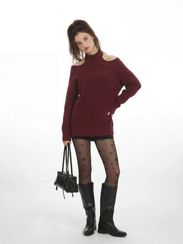 Model in a maroon open-shoulder sweater and star tights, holding a black handbag. Secondary image