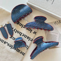 Selection of blue polka dot hair accessories with red trim laid out with text