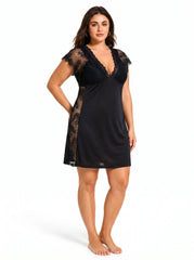Plus-size model in a black lace-trimmed chemise, front three-quarter view