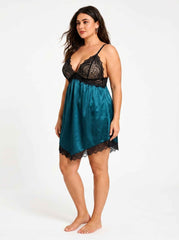 Side view of a woman wearing a teal satin slip dress with black lace detailing.
