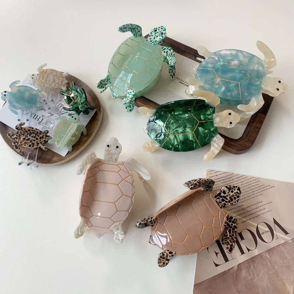 Various turtle hair clips, including large and small sizes, in pastel and jewel tones