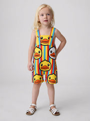 Child posing in a duck print shortall with a hand on hip.