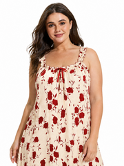 Close-up of a plus size woman wearing a cream and red floral print nightgown, showing the neckline