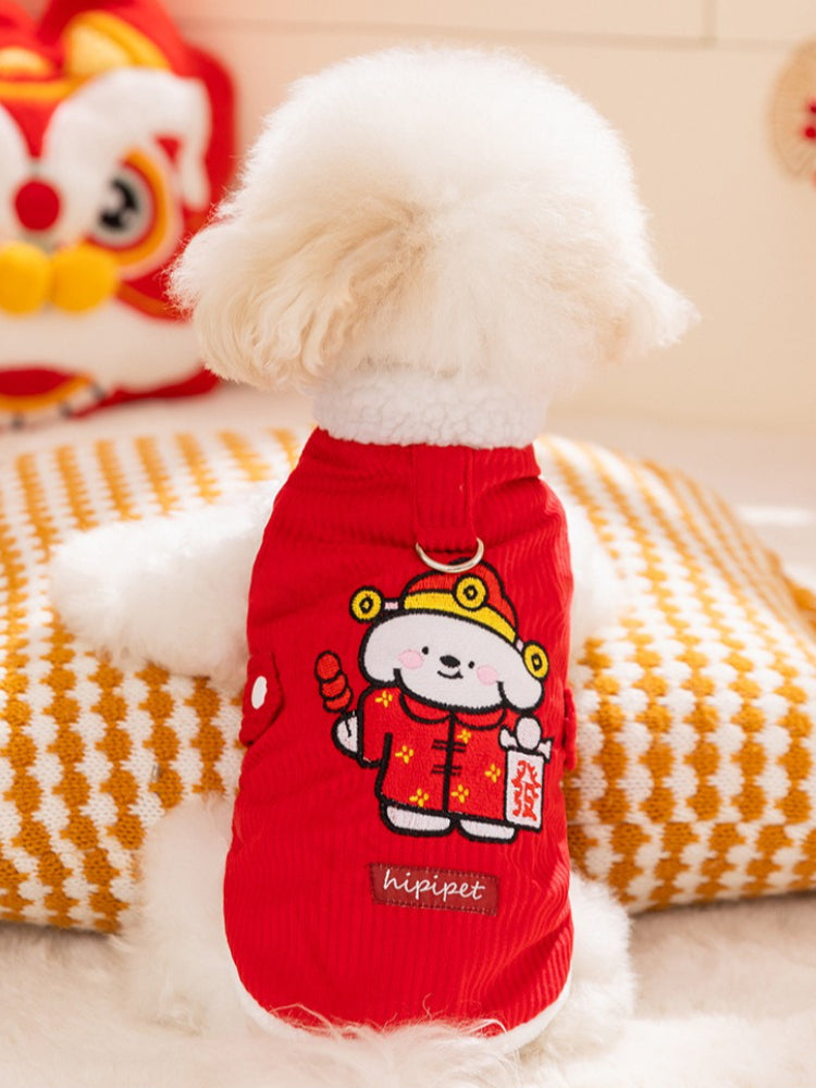 Back view of a white fluffy dog wearing a red corduroy vest with embroidered cartoon