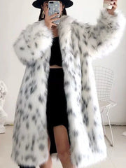 Full-length shot of a person in a spotted faux fur coat, black hat, and black dress, posing for a mirror selfie.