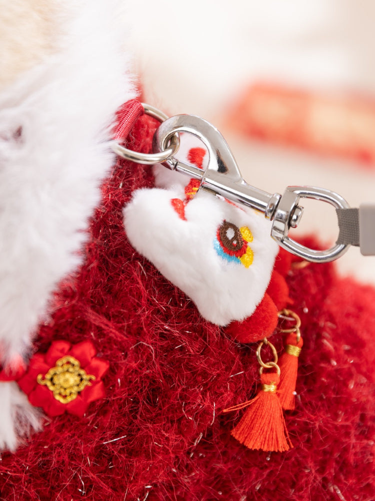 Close-up of the leash attachment and lion dance embellishment on a festive cat vest.