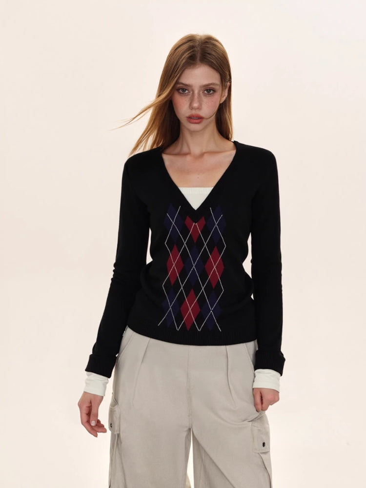 Full body shot of a woman in a black argyle sweater and cargo pants.