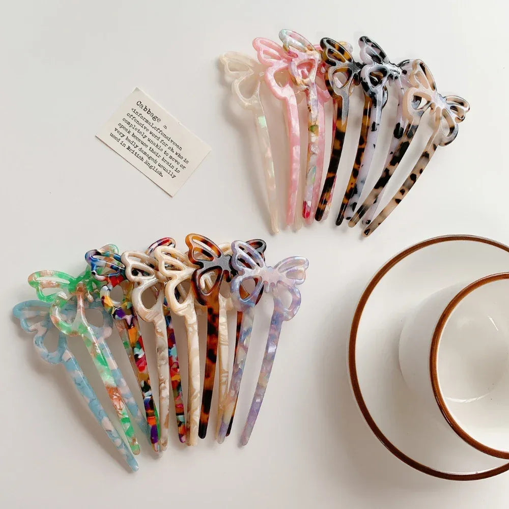collection of butterfly hair sticks in various colors and patterns