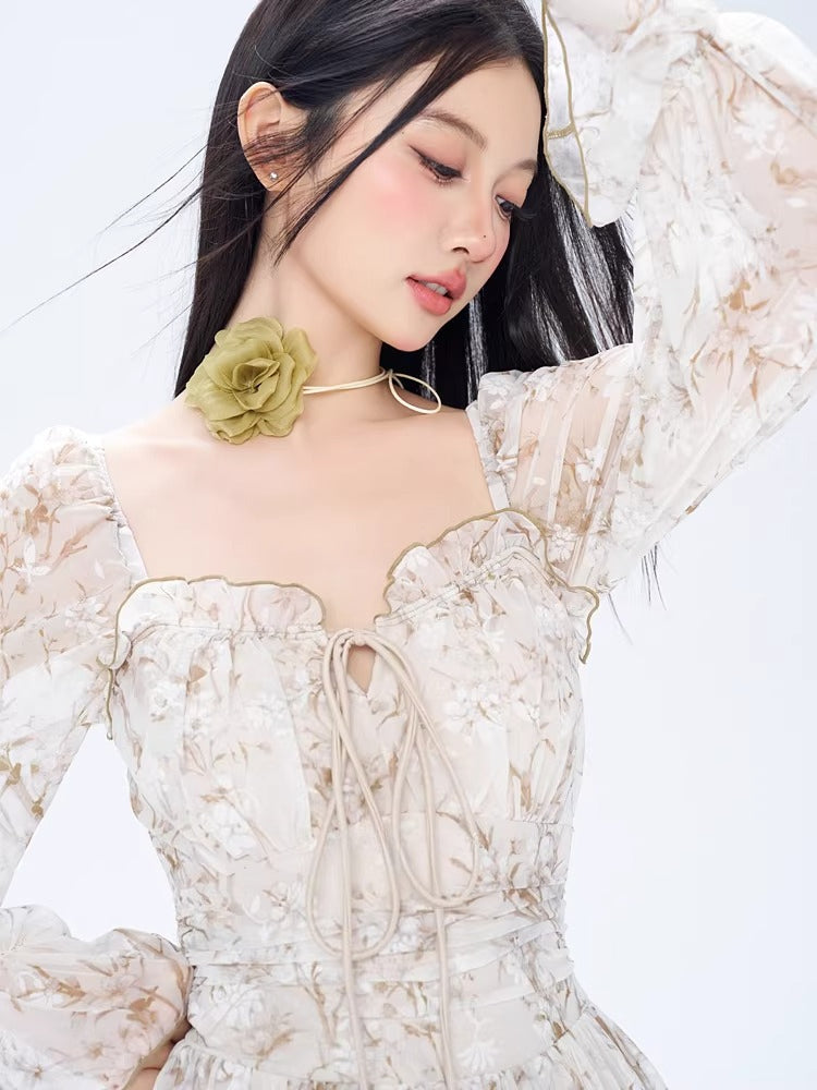 Close-up of a woman in a floral print dress, showing the neckline and choker detail.