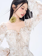 Close-up of a woman in a floral print dress, showing the neckline and choker detail.