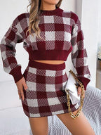 Woman wearing a burgundy and white gingham check knit cropped sweater and mini skirt set, holding a white handbag