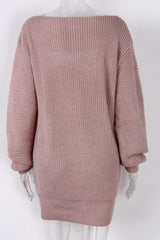 Back view of a pink off-the-shoulder ribbed knit tunic sweater on a mannequin.