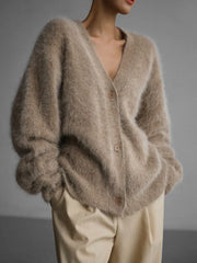 Close-up of a beige fuzzy V-neck button-up cardigan.