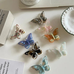 assortment of translucent butterfly hair clips on a white surface