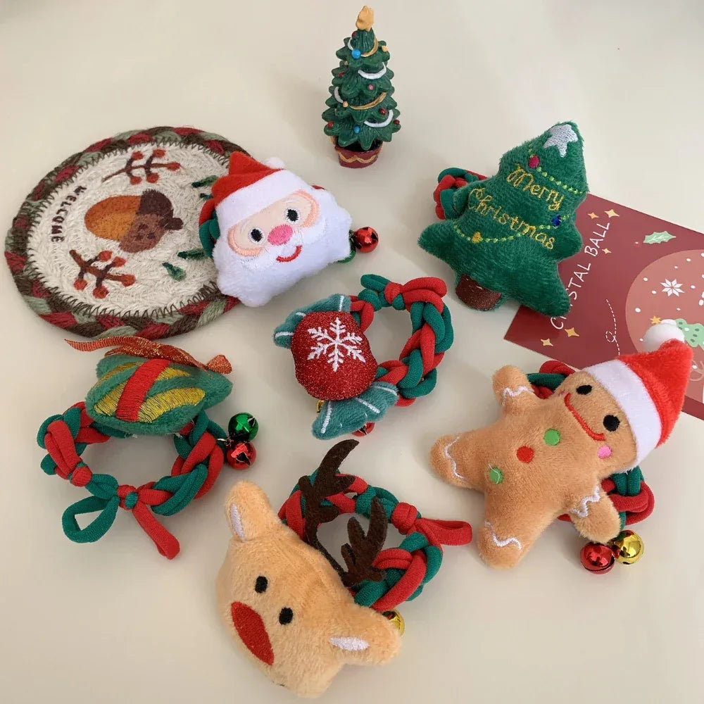Overhead view of plush Christmas ornaments and accessories, including Santa, gingerbread man, Christmas tree, reindeer, gift box, and snowflake wreath