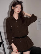 Woman posing in a brown corduroy shirt dress