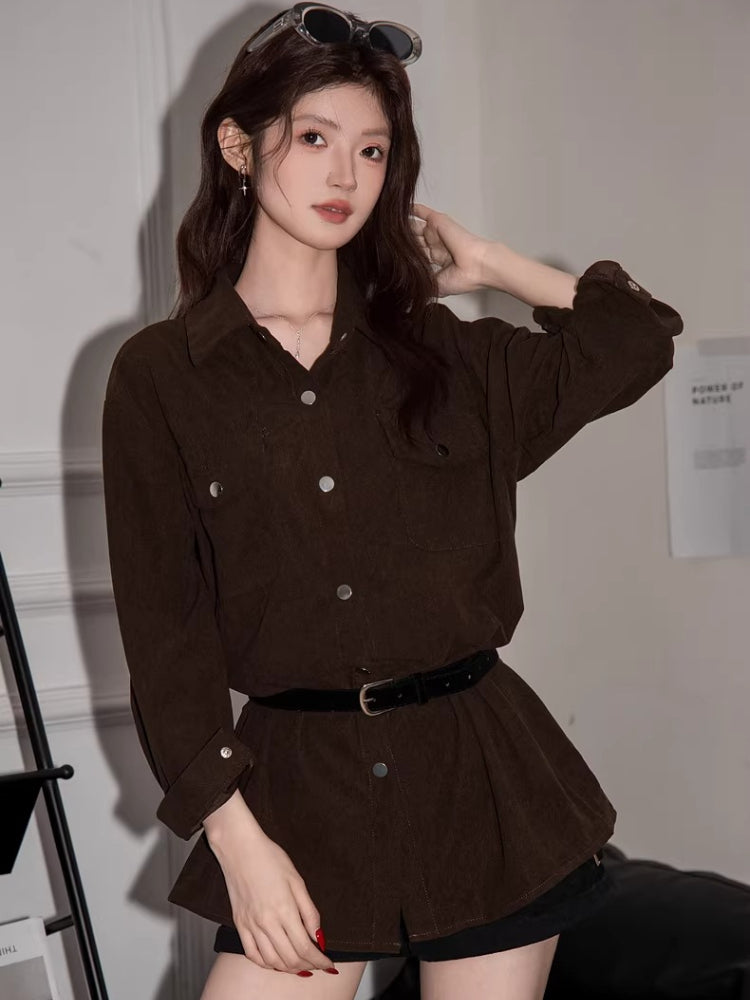 Woman posing in a brown corduroy shirt dress