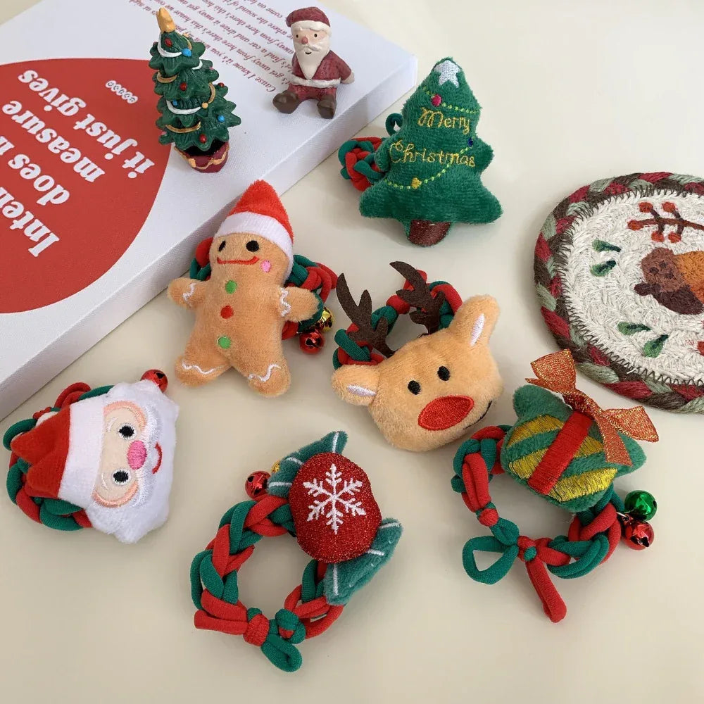 Close-up view of plush Christmas ornaments featuring Santa, gingerbread man, Christmas tree, reindeer, gift box, and snowflake wreath