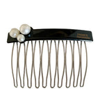 Close-up of a black hair comb with three white pearls on the top left and the inscription "FRANCE Handmade" on the top right, against a white background.