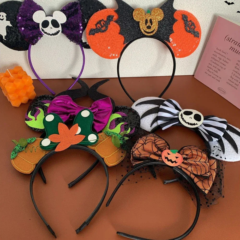 Close-up of Halloween Mickey Mouse ear headbands featuring pumpkins, bats, and Jack Skellington.