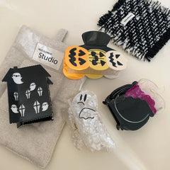 Assortment of Halloween themed hair accessories on a light-colored surface