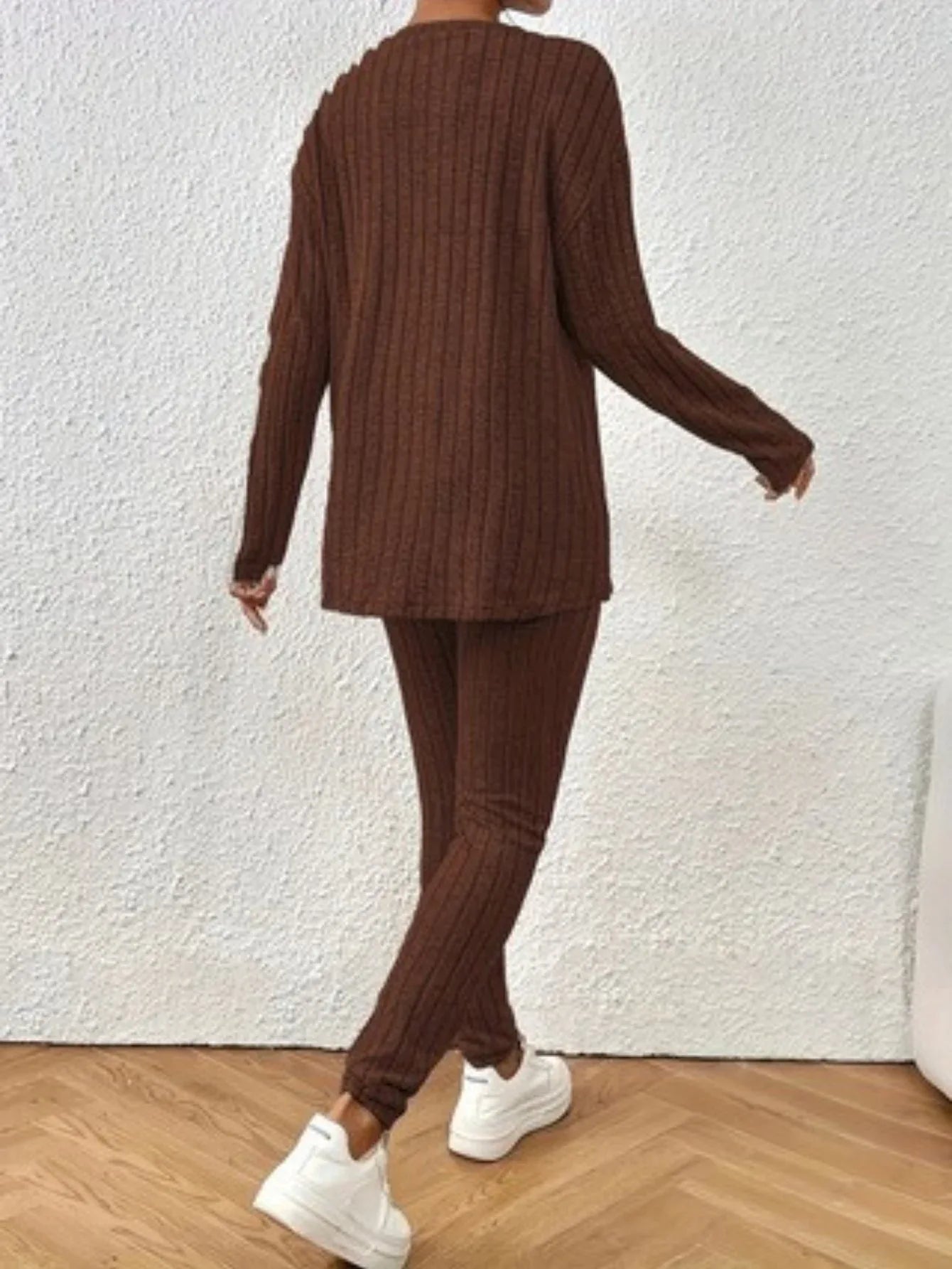 Back view of a woman wearing a brown ribbed knit loungewear set.