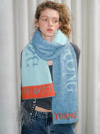 Full body shot of a model wearing a scarf with text.
