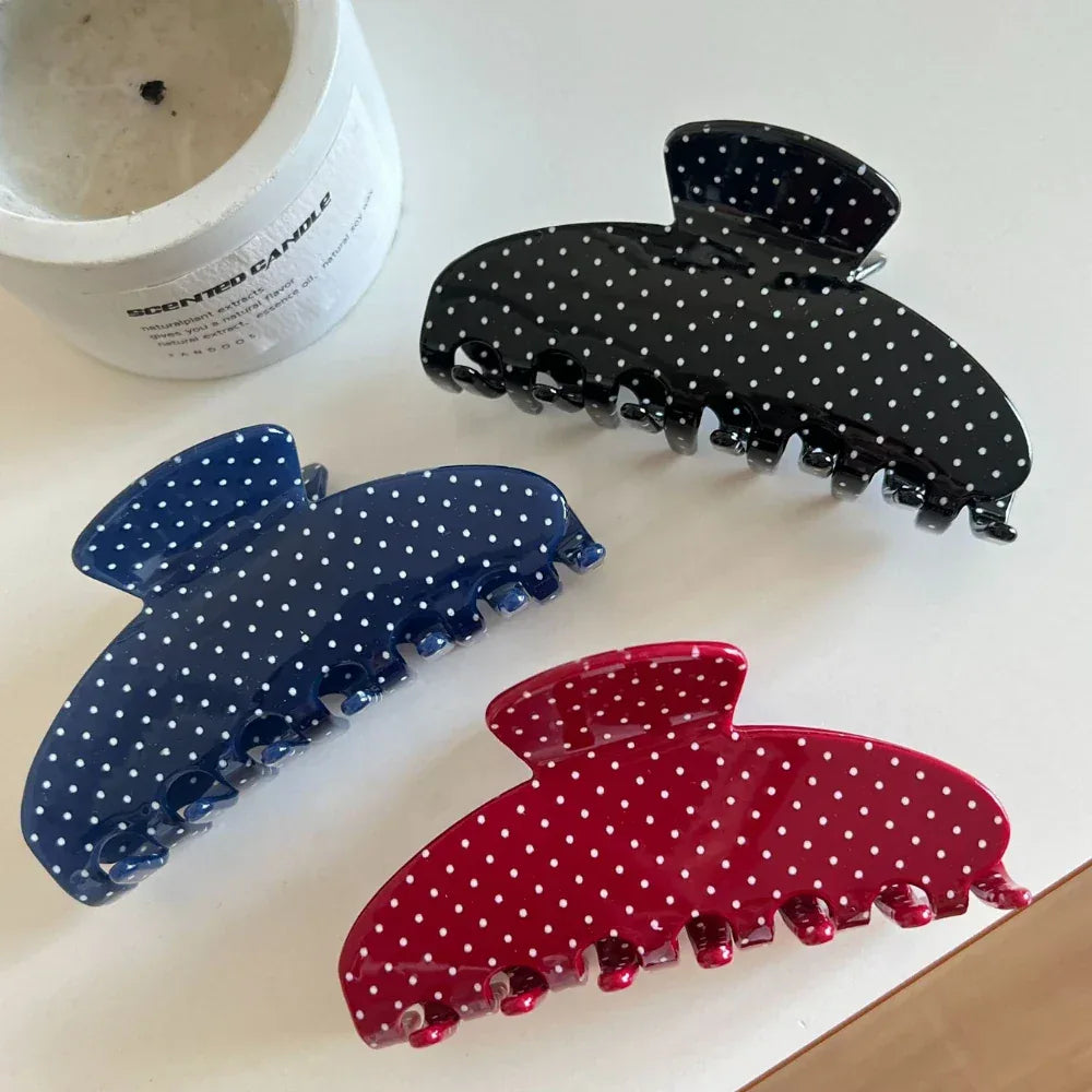 Set of polka dot hair claw clips in black, blue, and red