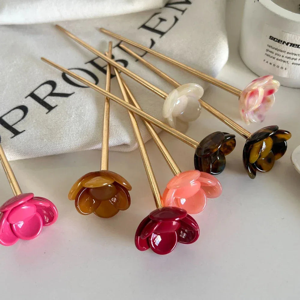 various flower hairpins lying on a surface