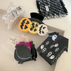 Overhead view of Halloween themed hair clips arranged on a tray