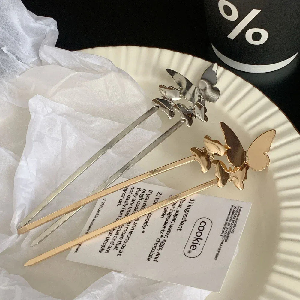 gold and silver butterfly hairpins on a plate