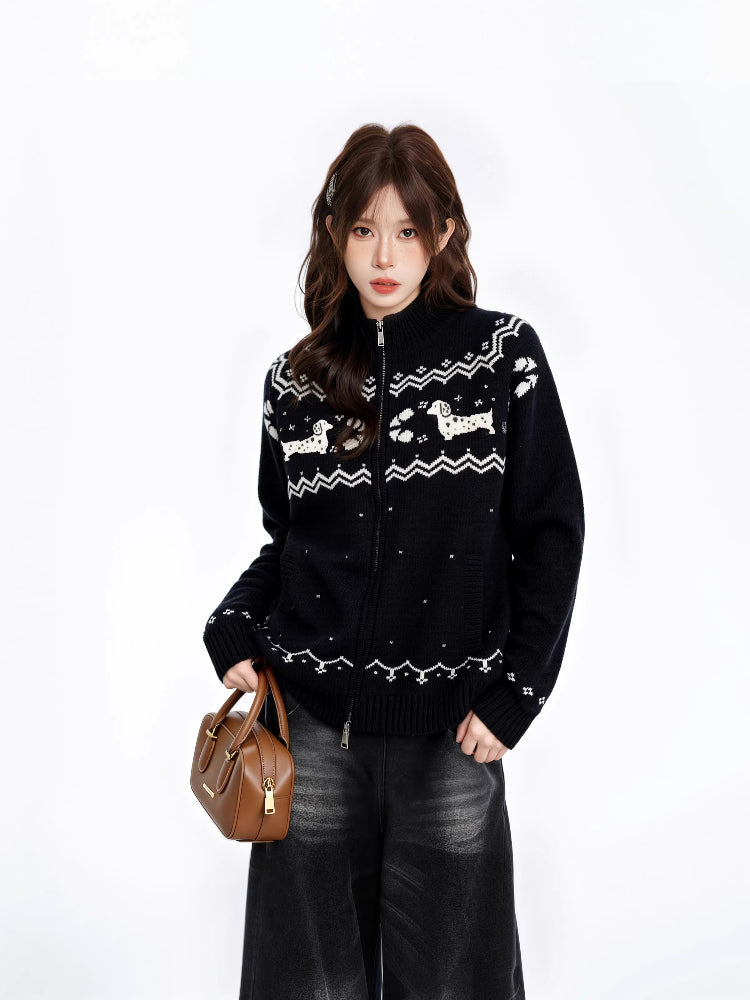 Woman wearing a black zip-up knit sweater with a white fair isle dog pattern and mock neck.