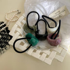 Set of decorative resin hair ties arranged on a tray