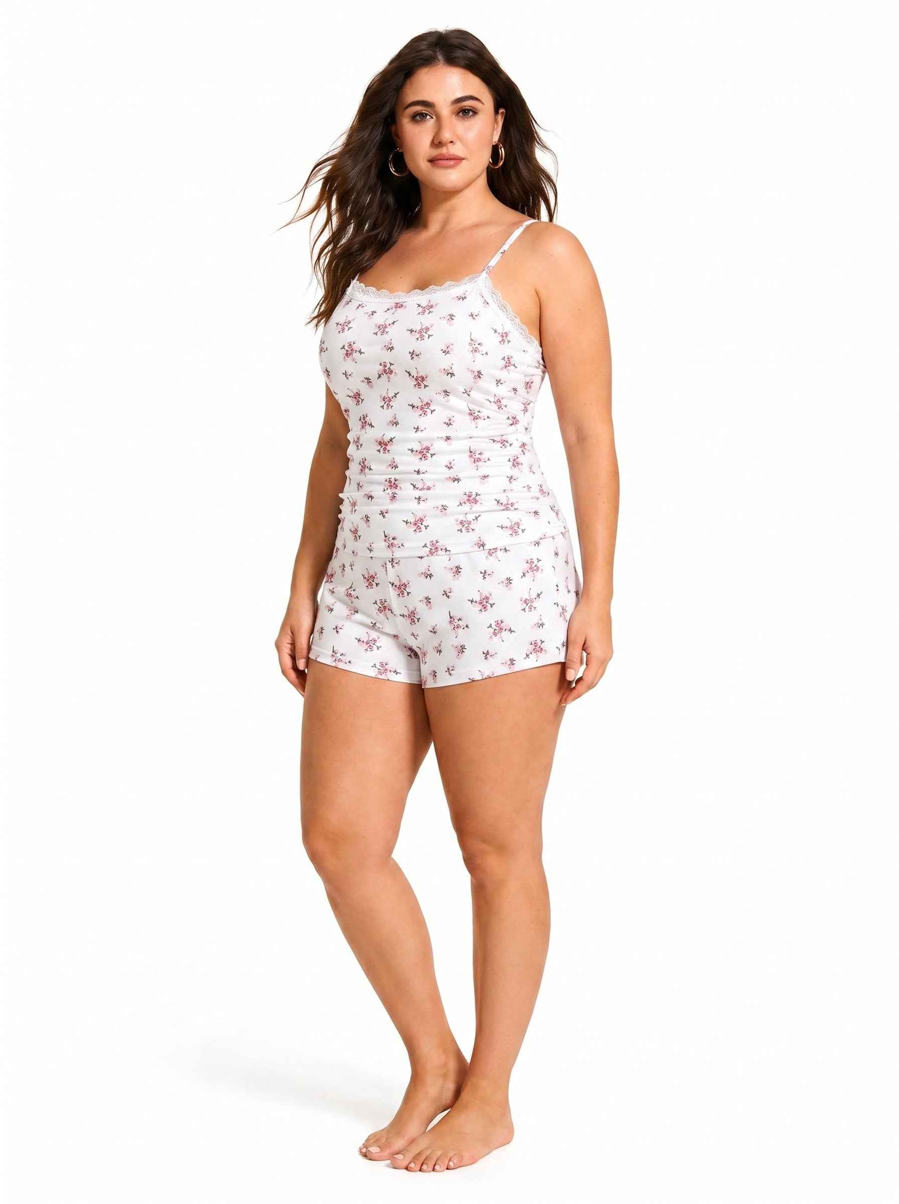 Woman standing in white floral print pajama set