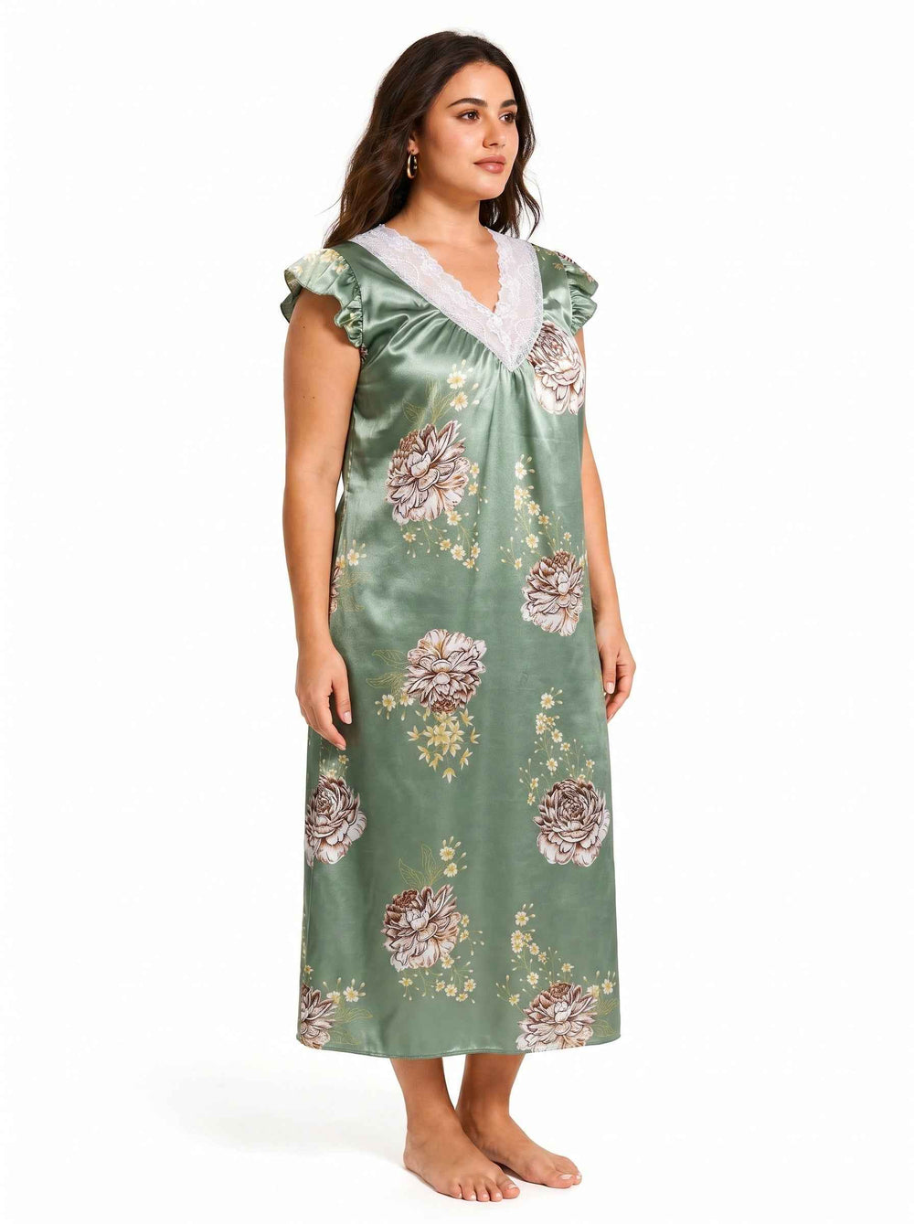 Full body shot of a woman in a green floral satin nightgown