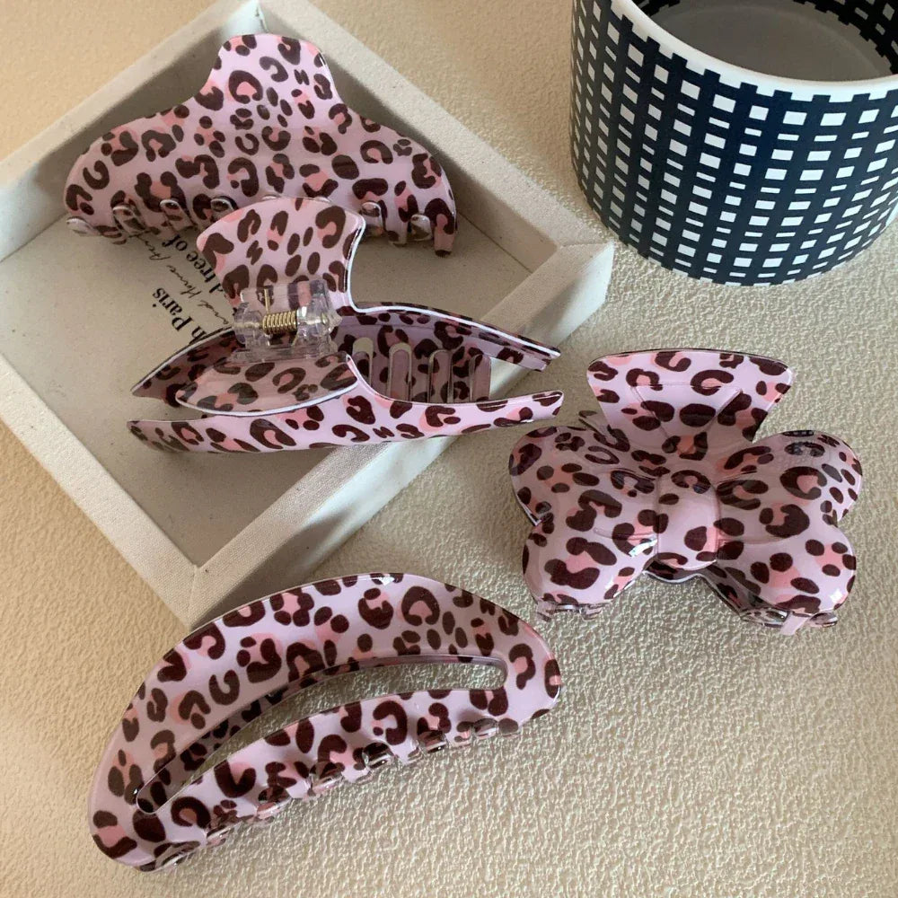 various pink leopard print hair claw clips arranged on a tray