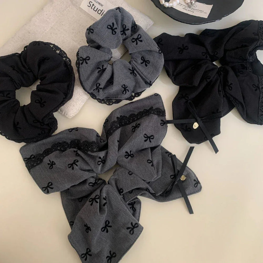 collection of scrunchies in black and grey with bow patterns and lace trim