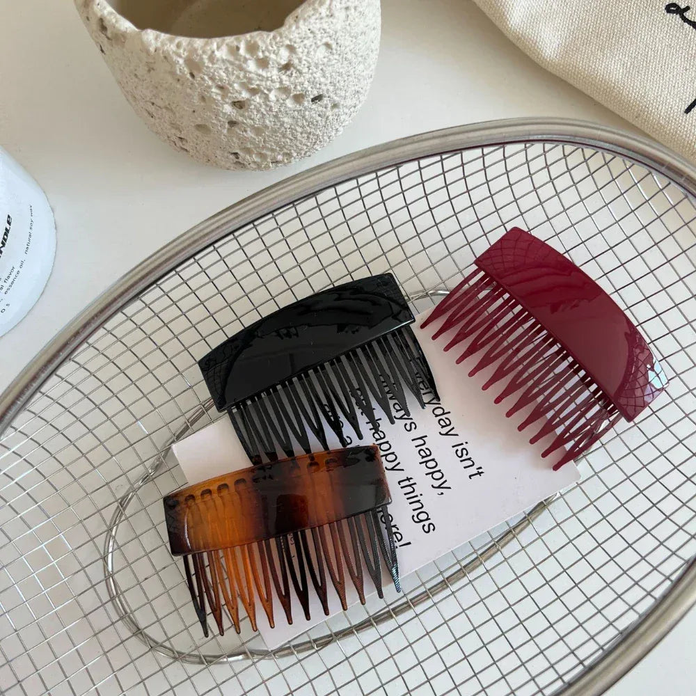hair combs arranged in a metal basket with a note