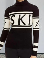 Woman's torso wearing a black and white turtleneck ski sweater with "SKI" graphic and stars.