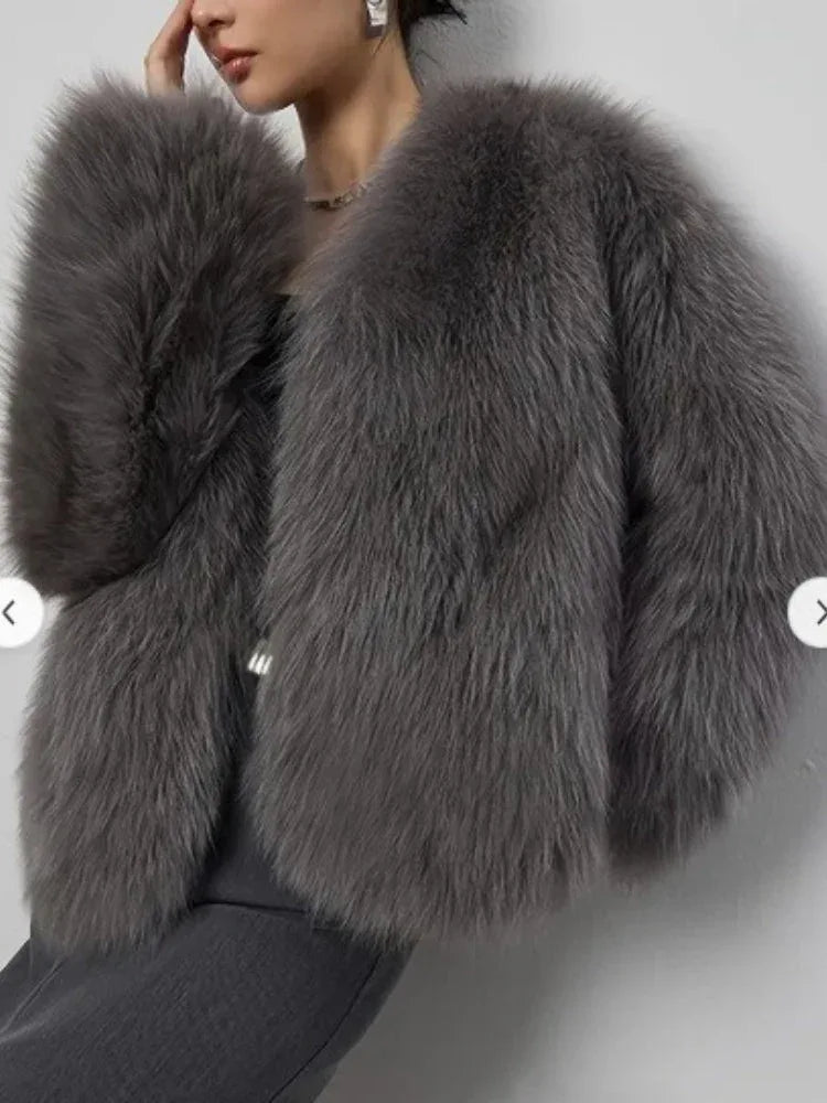 Close-up of a woman's grey faux fur cropped jacket.