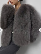 Close-up of a woman's grey faux fur cropped jacket.