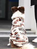 The back view of a brown and white Border Collie dog wearing a cream-colored fleece hoodie with a geometric pattern.