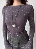 Close-up of a grey long-sleeve top with a white star print.