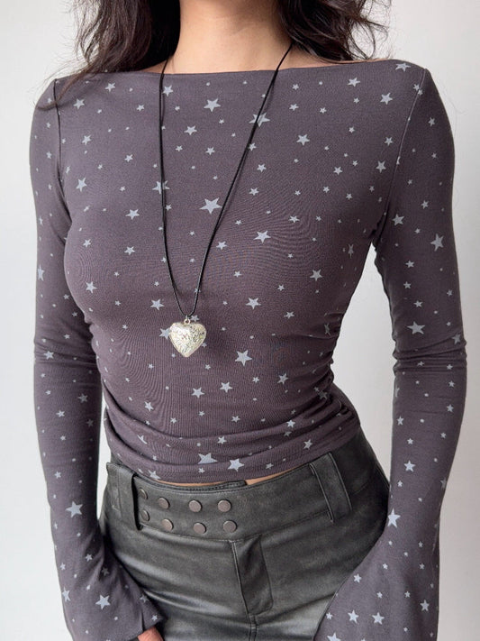 Close-up of a grey long-sleeve top with a white star print.
