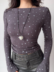 Close-up of a grey long-sleeve top with a white star print.