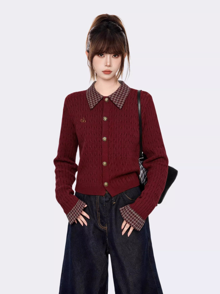 Front view of a woman in a burgundy cable knit cardigan with plaid accents.