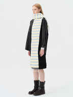 model wearing a black leather jacket and a light yellow and blue striped scarf