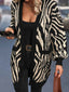 Woman wearing a black and white zebra print longline knit cardigan with an open front.